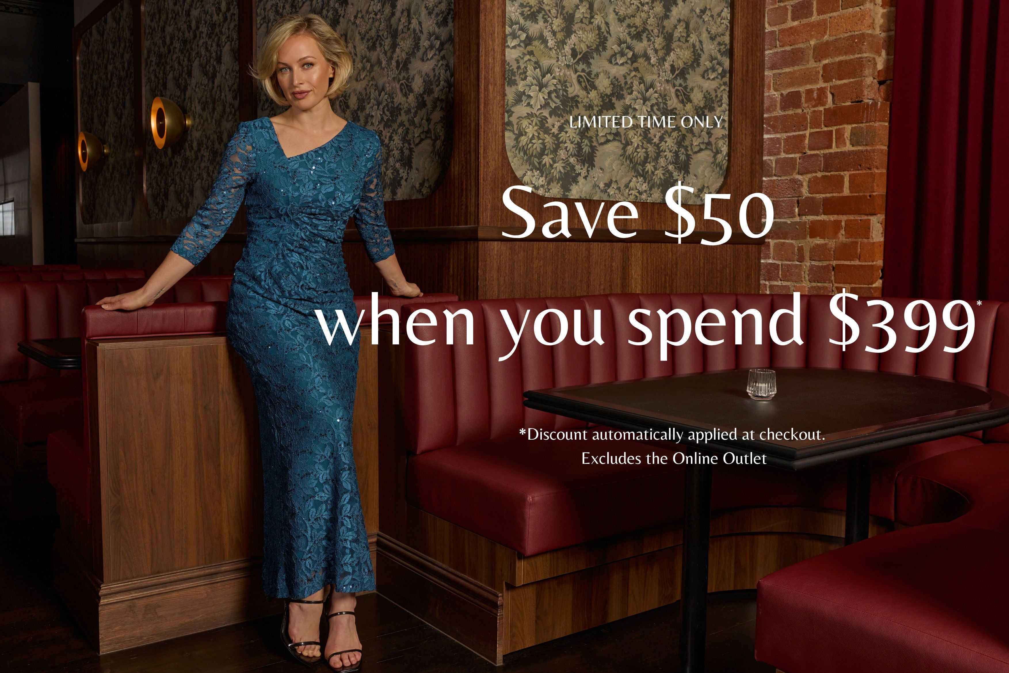 Woman in a blue lace dress standing in a restaurant with promotional text overlay. Save $50 on orders over $399*