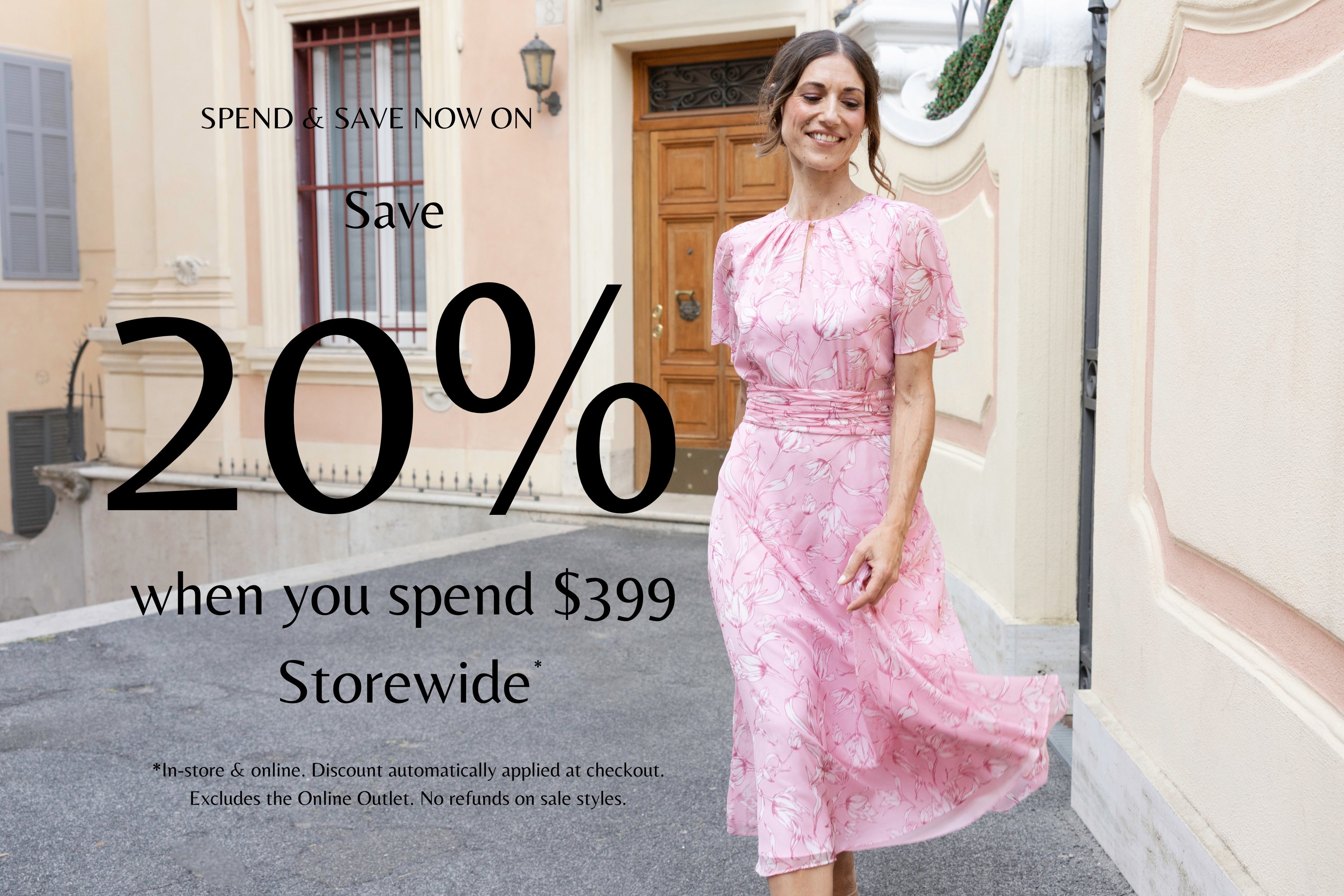 Spend & Save Now On- Save 20% when you spend $399 storewide. Model in an outdoor setting wearing the Georgia Pink Floral Chiffon Dress.