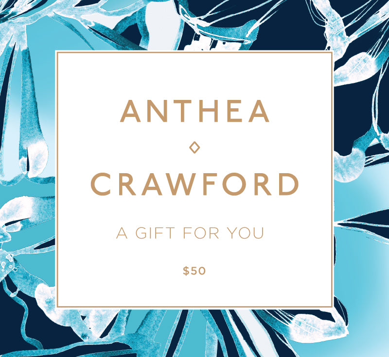 Gift card with 'Anthea Crawford' branding and a decorative blue and white design. $50 Online Gift Card