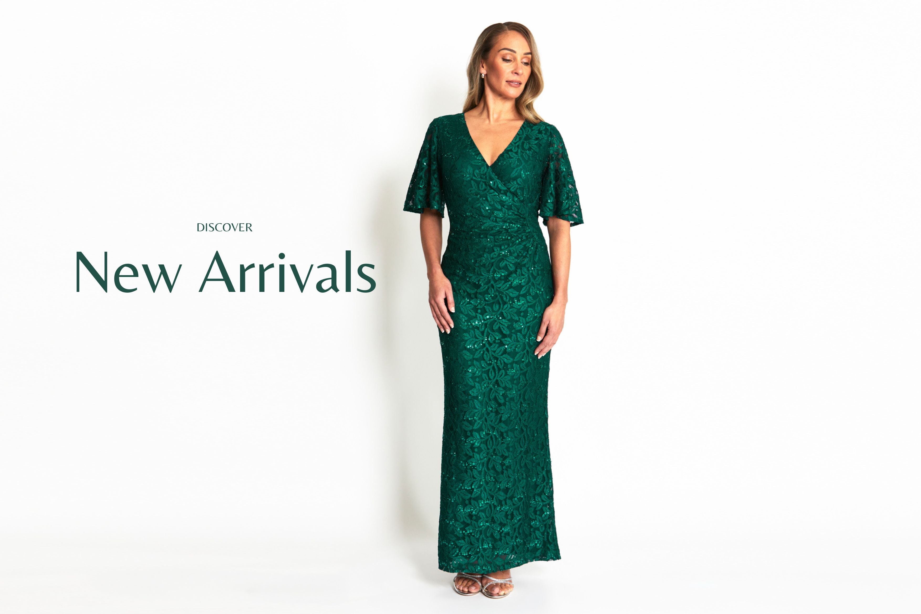 Woman wearing a green dress with 'New Arrivals' text on a white background. Esme Forest Lace Gown