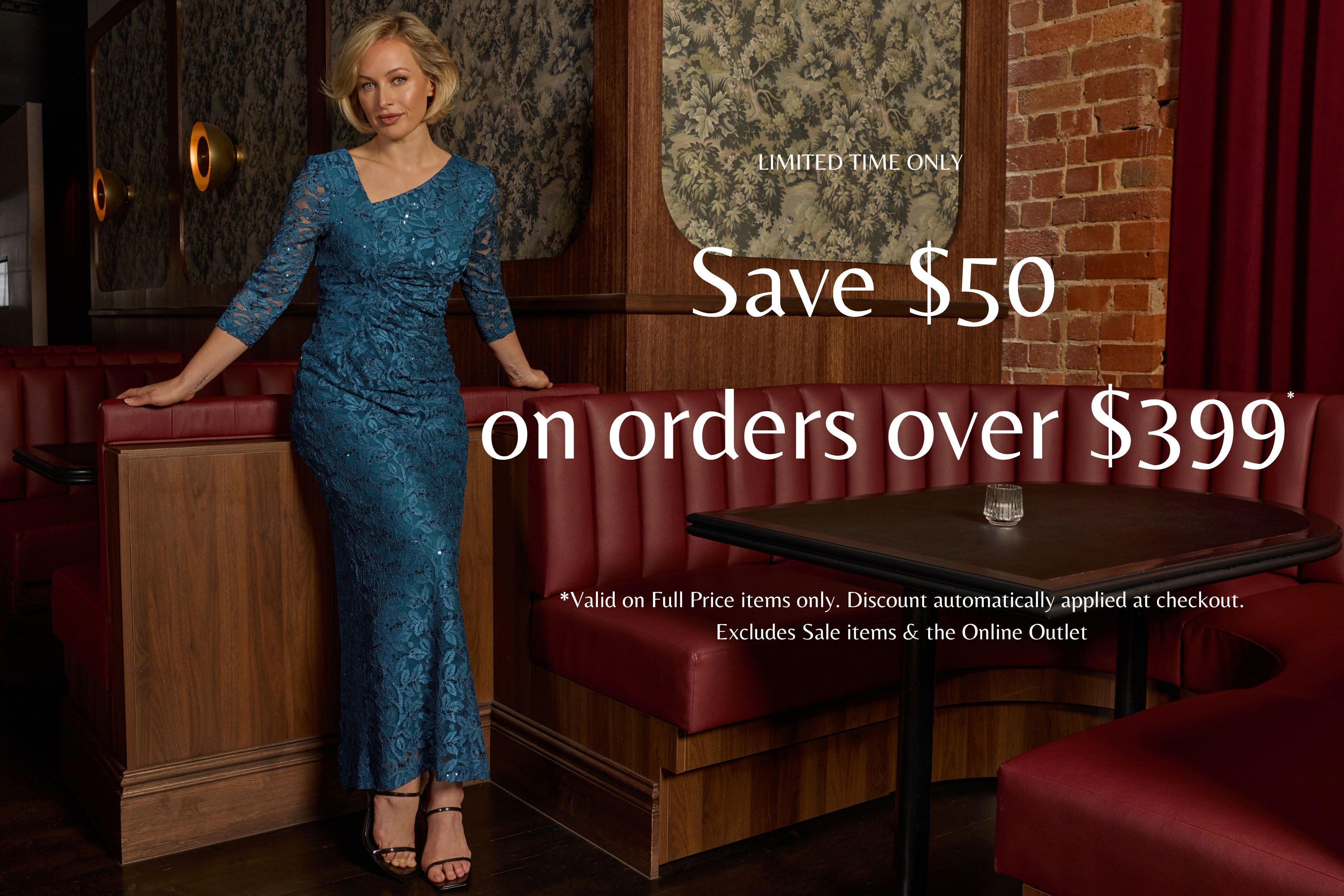 Woman in a blue  lace dress standing in a restaurant with promotional text overlay. Save $50 on orders over $399*