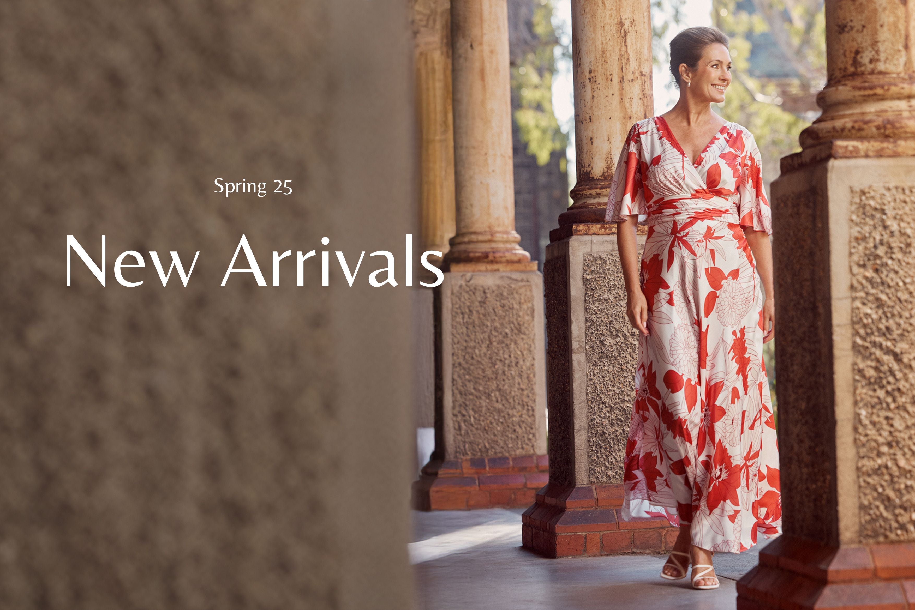 Woman in a floral dress standing in an outdoor setting with 'New Arrivals' text overlay. Elena Vermilion Floral Gown